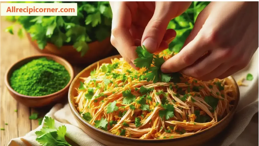 Garnishing Shredded Pepperoncini Chicken with Fresh Herbs